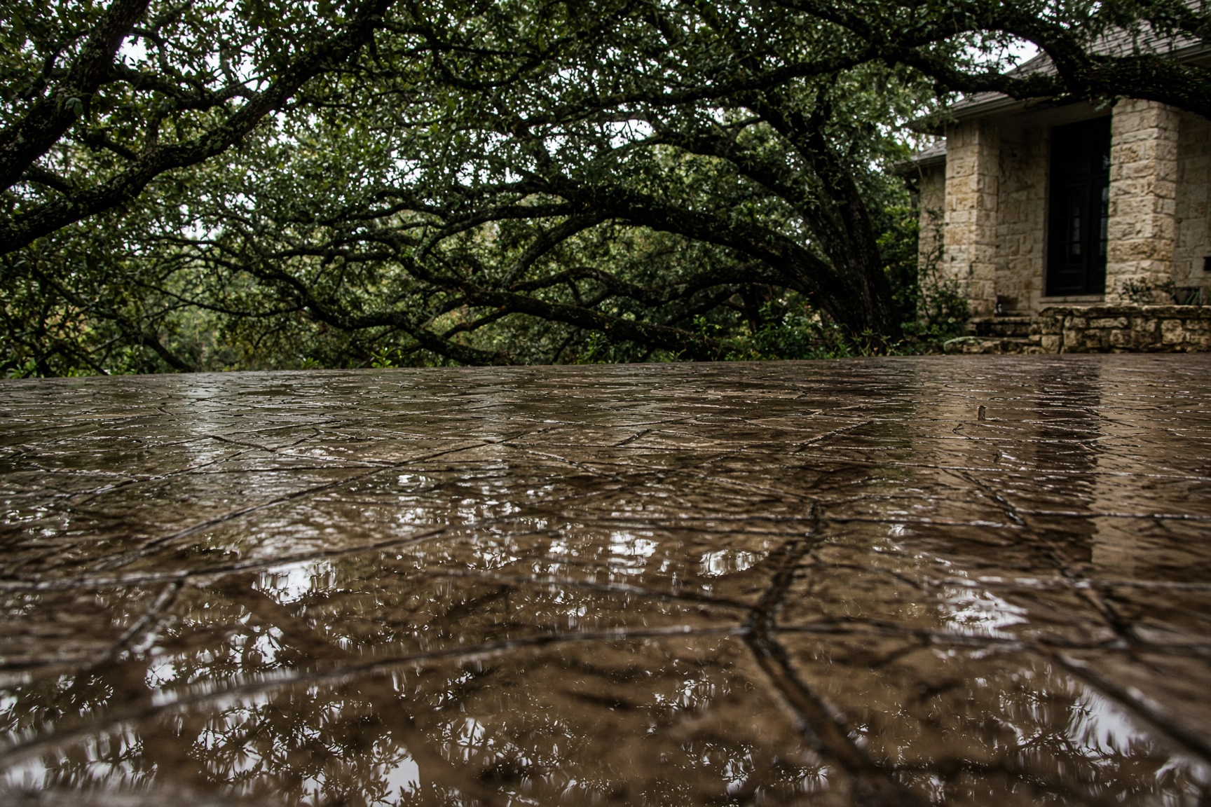 Sealed decorative concrete reflecting a Texas Hill Country house